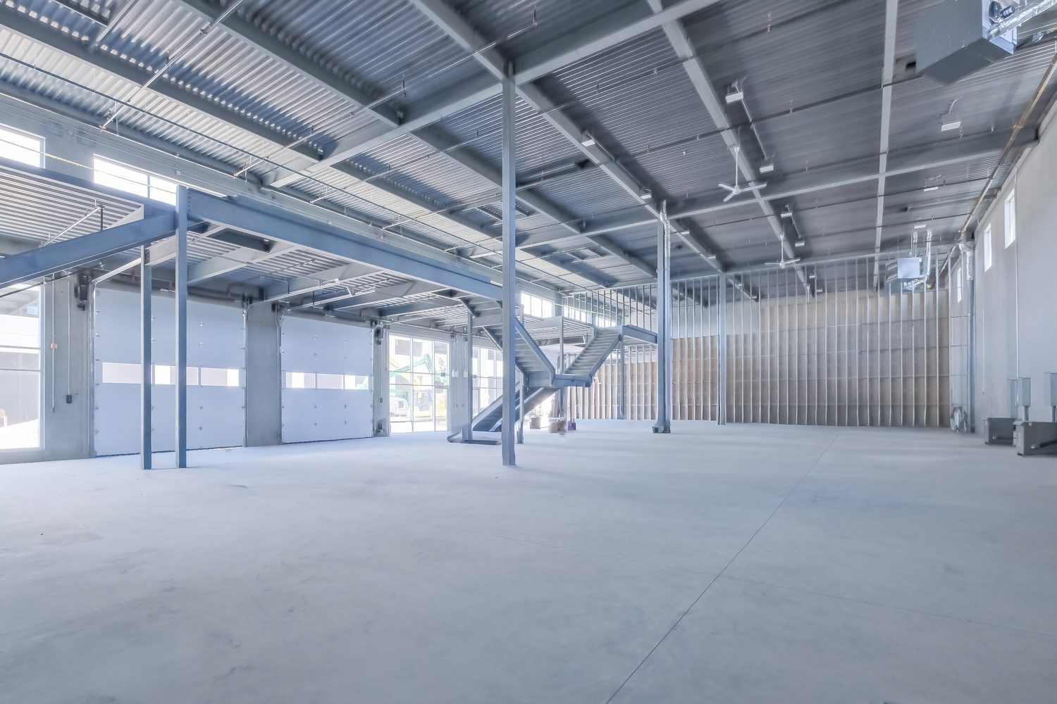 Unit interior with mezzanine stairs in progress