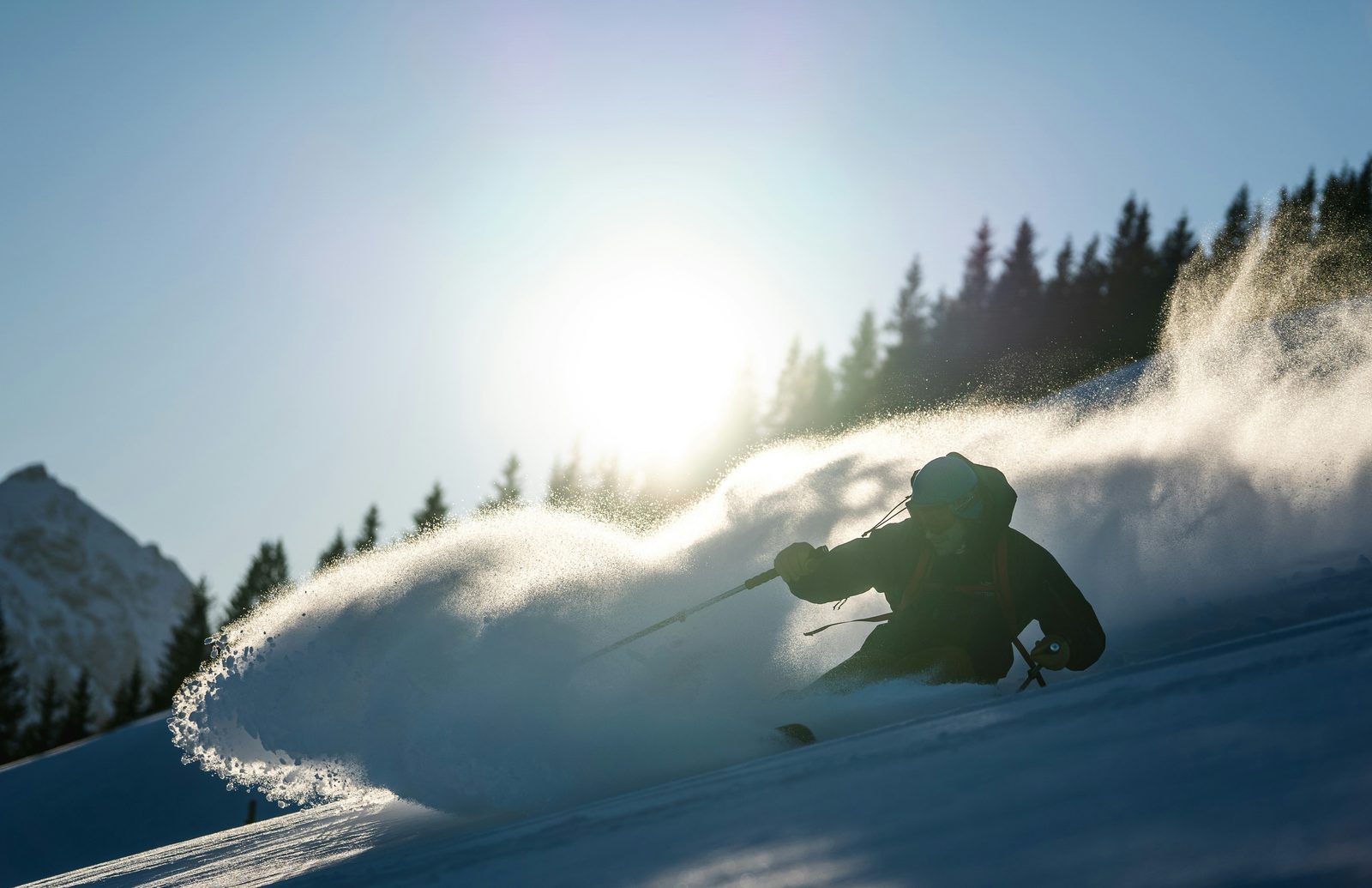 Skier carving through fresh powder