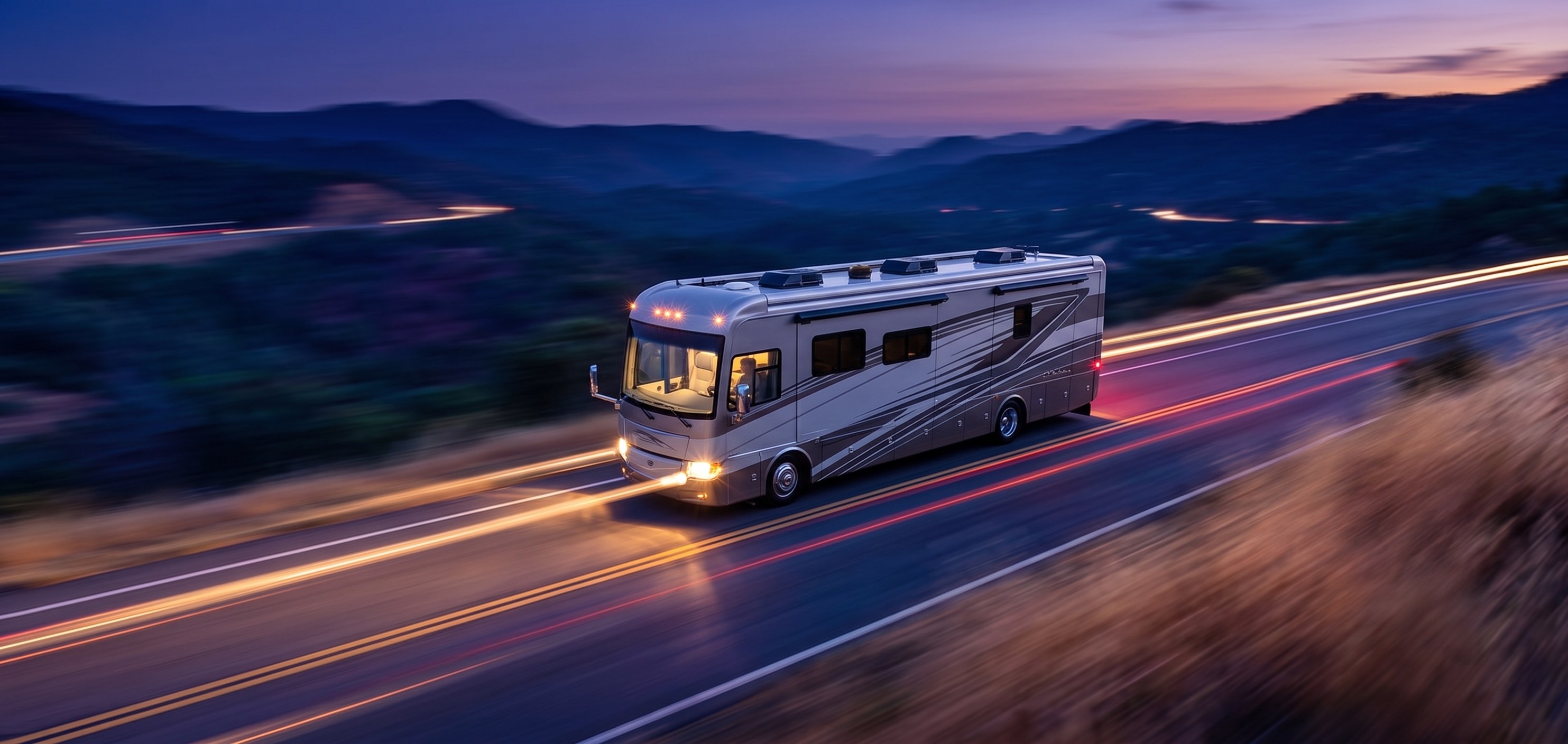 Motorhome driving a mountain highway at dusk